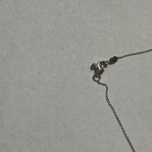 Roberto Coin 18 kt white gold and 7 diamonds viable on both sides.